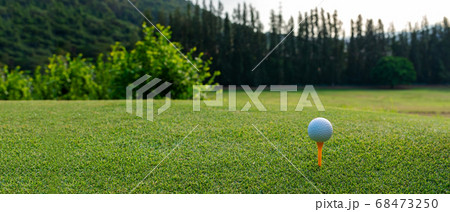 Close up Golf club hitting golf ball along fairway towards green  68473250