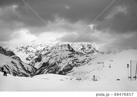 Snowy ski slope with skier and snowboarder in high Snowy ski slope with skier and snowboarder in high 68476857