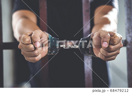 Handcuffed prisoner in jail 68479212