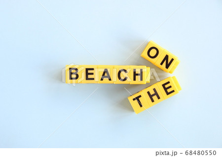 on the beach concept, inscription in yellow letters on a blue background on the beach concept, inscription in yellow letters on a blue background 68480550
