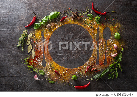 Spices and herbs scattered on the table forming Spices and herbs scattered on the table forming 68481047