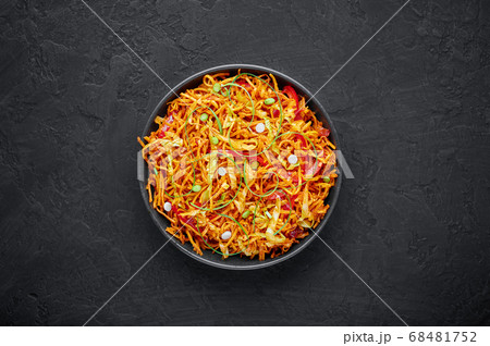 Chinese Bhel in black bowl on dark slate table Chinese Bhel in black bowl on dark slate table 68481752