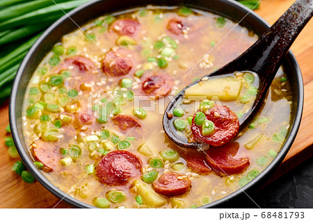 Dry Yellow Pea Soup with meat sausages, potato in black bowl 68481793