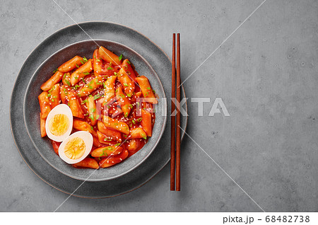 Tteokbokki with eggs in gray bowl on concrete table top Tteokbokki with eggs in gray bowl on concrete table top 68482738