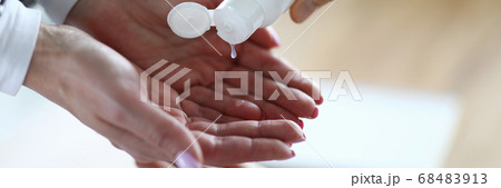 Lady applying antiseptic to clean hands Lady applying antiseptic to clean hands 68483913