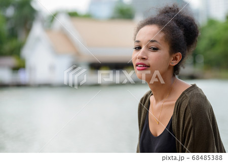 Portrait of happy young beautiful African woman at the park Portrait of happy young beautiful African woman at the park 68485388