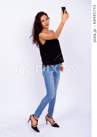 Portrait of young beautiful woman taking selfie 68485743