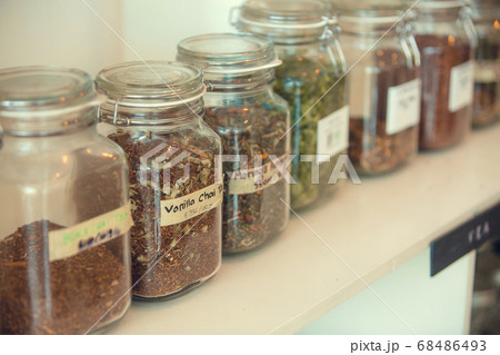 Eco friendly glass jars and bottles on shelves of zero waste store shop filled with nuts, seeds, tea, grains. Sustainable plastic free lifestyle Eco friendly glass jars and bottles on shelves of zero waste store shop filled with nuts, seeds, tea, grains. Sustainable plastic free lifestyle 68486493