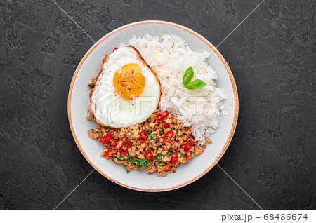 Pad Krapow Gai - Thai Basil Chicken with Rice and fried Egg black slate table top Pad Krapow Gai - Thai Basil Chicken with Rice and fried Egg black slate table top 68486674