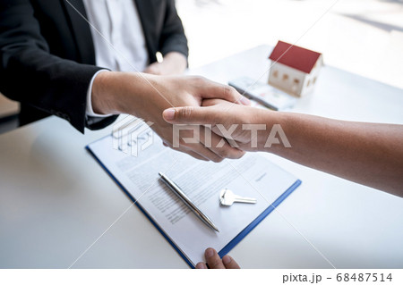 Real estate agent are shaking hands after good 68487514