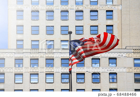 waving american flag in front of office 68488466