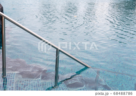 Ladder stainless handrails for descent into swimming pool.  68488786