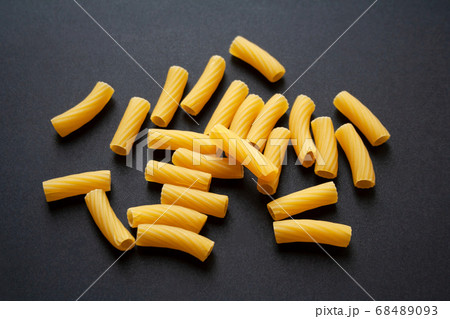 Heap of raw tortiglioni pasta isolated on black background	 68489093