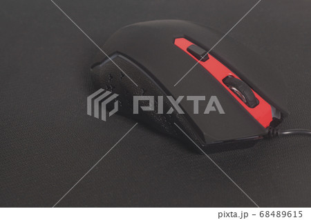 Computer modern gaming mouse on black mouse pad 68489615