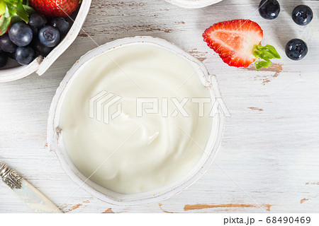 Bowl of natural yogurt with granola and fresh berries Bowl of natural yogurt with granola and fresh berries 68490469