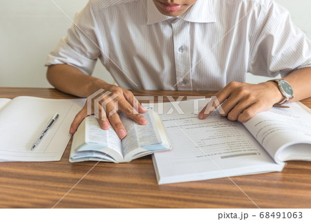 Young student reading books and studying 68491063
