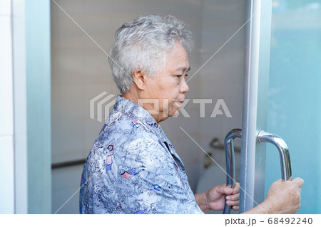 Asian senior or elderly old lady woman patient use toilet bathroom handle security 68492240