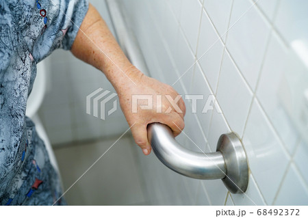 Asian senior or elderly old lady woman patient use toilet bathroom 68492372