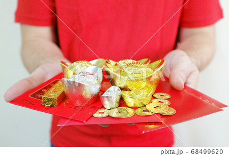 Hands give Gold and silver and red envelope "Ang Pao". Hands give Gold and silver and red envelope "Ang Pao". 68499620
