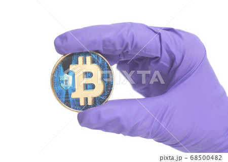 Hand in Purple Glove holds Bitcoin Crypto 68500482