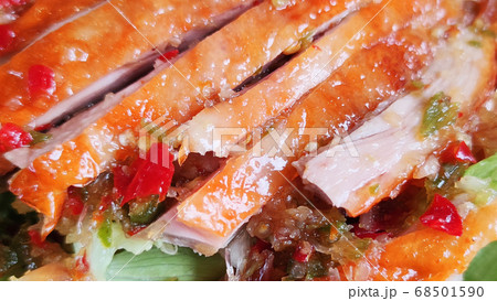 Sliced roasting Traditional Christmas Duck dressing with salad tomatoes and spicy sweet sauce at gourmet chinese restaurant, food advertisement backgrounds 68501590