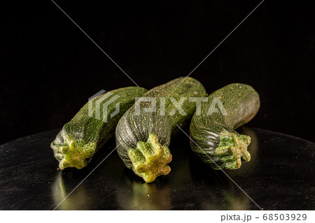 Ripe zucchini on a black background close up 68503929