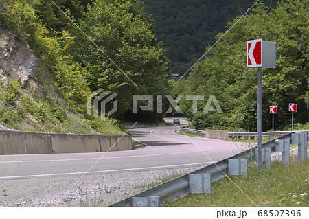 Curved asphalt road in high mountains. summer day Curved asphalt road in high mountains. summer day 68507396