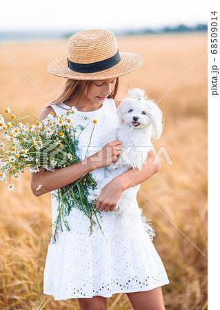 Happy child in wheat field. Beautiful girl in white dress outdoors 68509014