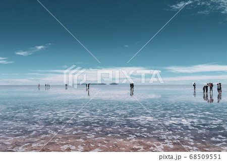 People silhouette and reflections in the Salar de Uyuni, Bolivia 68509551