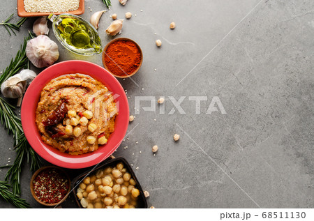 Hummus topped with chickpeas, olive oil, green 68511130