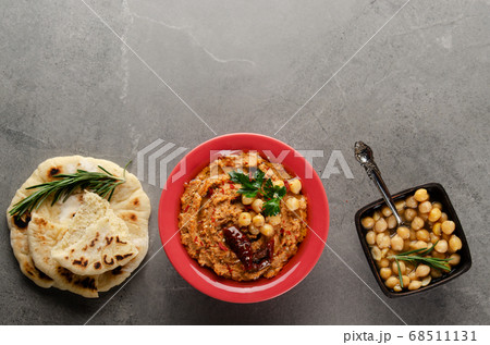 Flat lay Hummus with sun dried tomatoes in clay 68511131