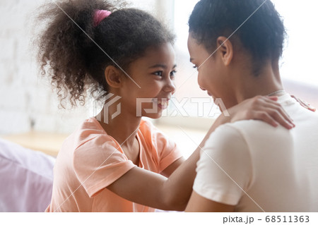 Affectionate loving black mother and daughter enjoying happy moments together 68511363
