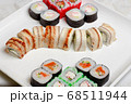 set of different types of sushi on a white plate 68511944