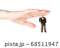 House keys in the female hand on a white background 68511947
