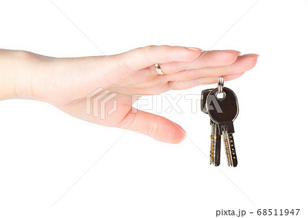 House keys in the female hand on a white background House keys in the female hand on a white background 68511947