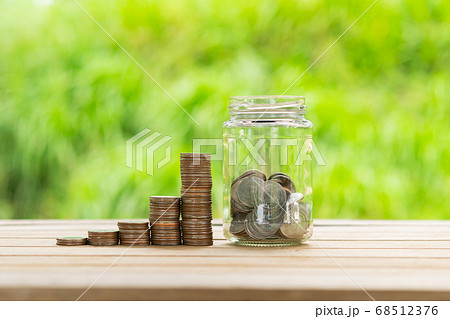 Coin Stack , coin in Glass bottle  in green bokeh 68512376