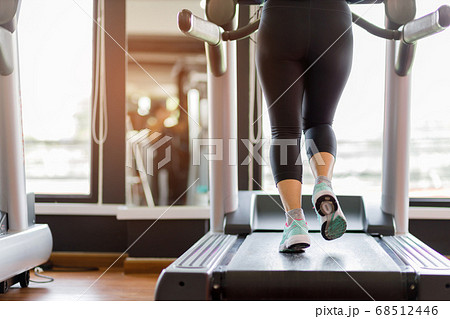 Close up foot sneakers Fitness girl running on track treadmill 68512446