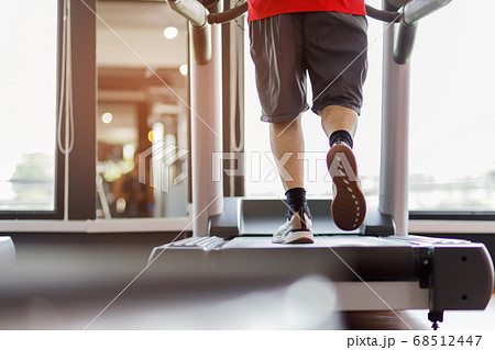 Close up foot sneakers Fitness man running on track treadmill 68512447