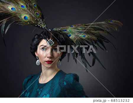 Beautiful woman in retro style with feather Beautiful woman in retro style with feather 68513232