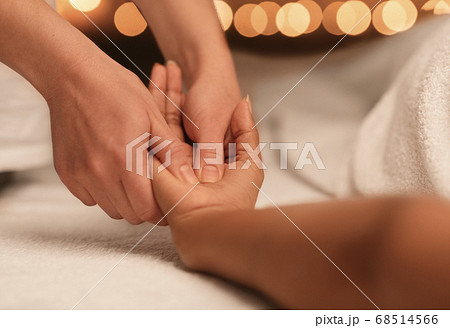 Spa therapist massaging african lady hand, closeup Spa therapist massaging african lady hand, closeup 68514566