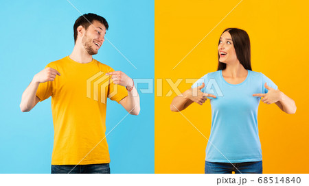 Happy young man and woman pointing fingers at themselves Happy young man and woman pointing fingers at themselves 68514840