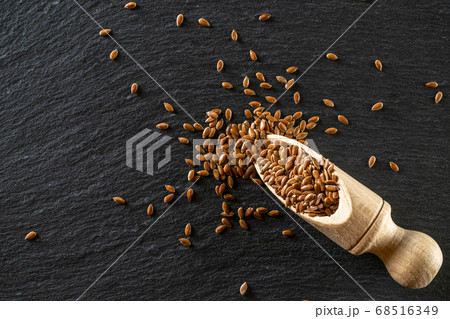 Flaxseed isolated on dark stone. Brown linseed, Flaxseed isolated on dark stone. Brown linseed, 68516349