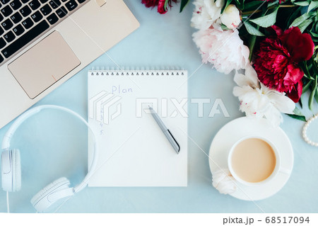 Feminine Overhead workspace with laptop, notebook and coffee. 68517094