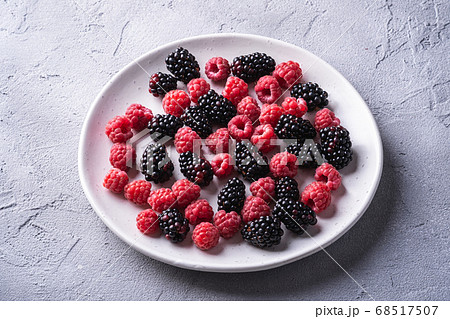 Tasty fresh ripe raspberry and blackberry berries in plate Tasty fresh ripe raspberry and blackberry berries in plate 68517507
