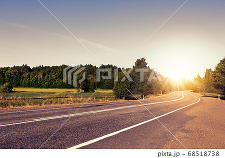 Country asphalt road, green fields and forest at Country asphalt road, green fields and forest at 68518738