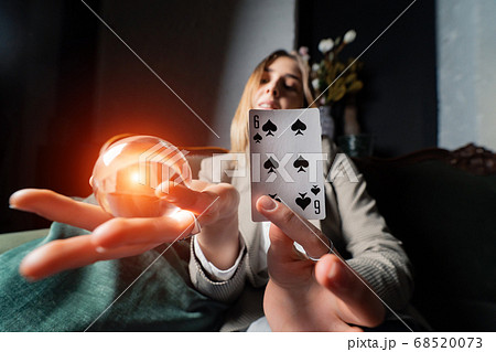 Woman in business suit holding crystal ball and six spade Woman in business suit holding crystal ball and six spade 68520073