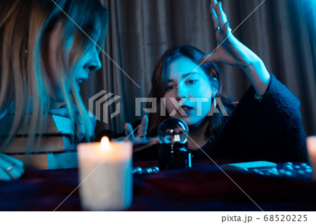 Woman and woman fortune teller with crystal ball Woman and woman fortune teller with crystal ball 68520225