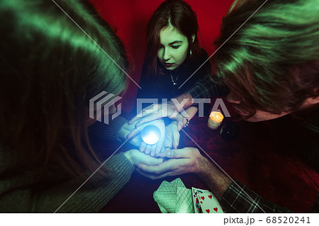 Group of people and woman fortune teller with crystal ball Group of people and woman fortune teller with crystal ball 68520241