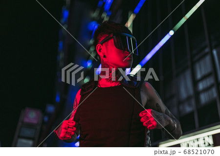 Cyberpunk style. Tattooed guy in one city. Cyber glasses. Cyberpunk style. Tattooed guy in one city. Cyber glasses. 68521070