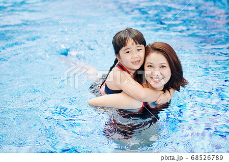 Mom and daughter in swimming pool Mom and daughter in swimming pool 68526789